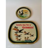 Two Guinness tinplate advertising drinks trays.