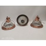 Set of three copper and glass hanging light shades.