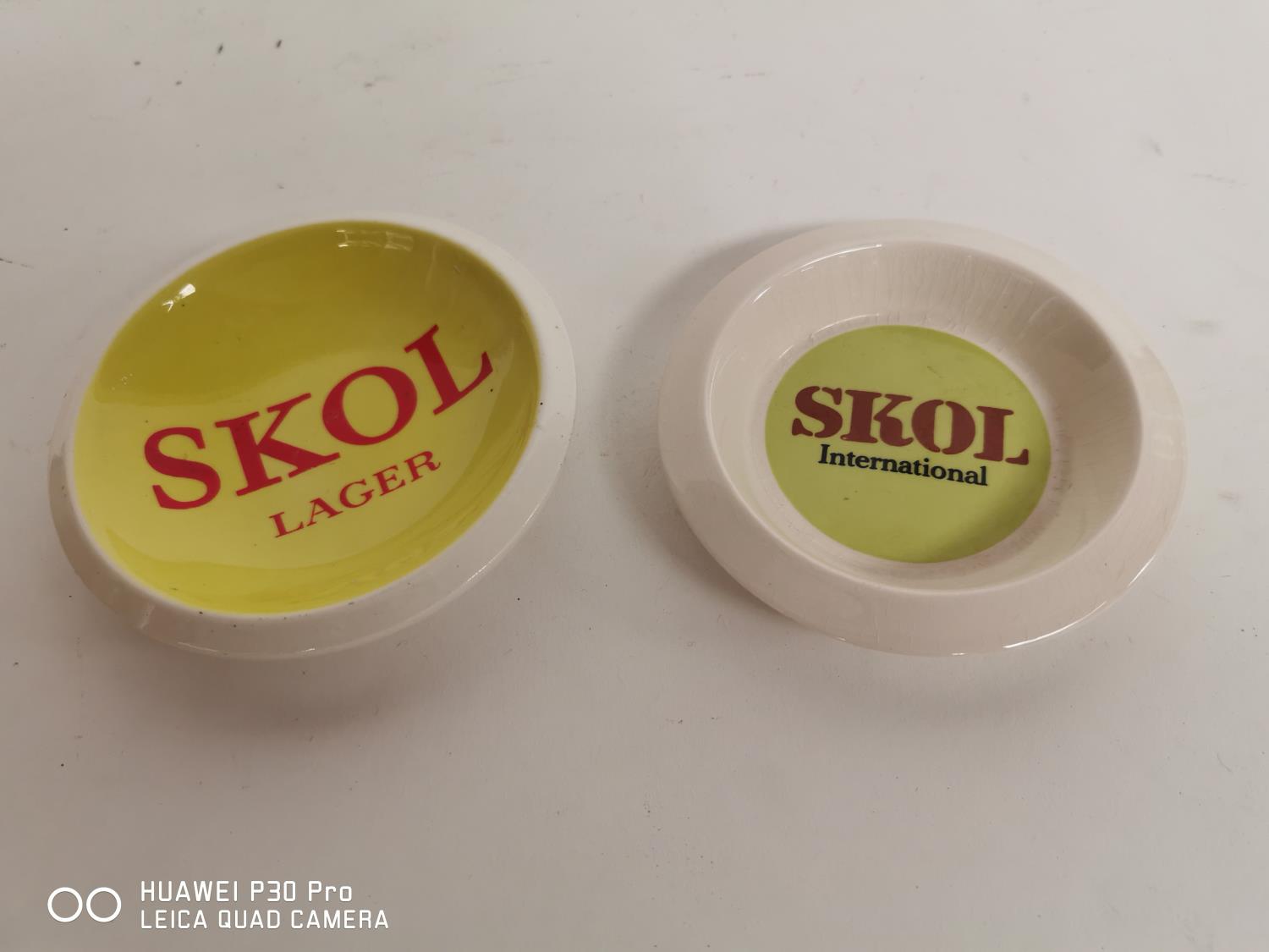 Two Skol Lager ashtrays.