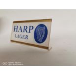 Harp Lager counter advertising sign.