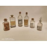 Collection of five perfume and lotions bottles.