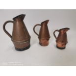 Set of three 19th. C. copper jugs.