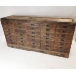 Late 19th C. bank of thirty five drawers with original brass handles.