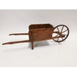 Early 20th C. elm child's wheel barrow {35 cm H x 118 cm W x 35 cm D}.