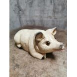 Cast iron money bank in the form of a pig. {9 cm H x 22 cm W x 10 cm D}