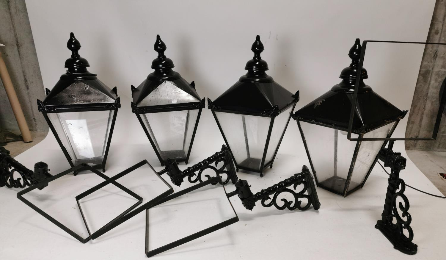 Set of four painted brass lanterns with wall brackets. {82 cm H x 43 cm W x 82 cm D}.