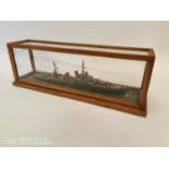 Model of a battle ship mounted in a glazed case { 21cm H X 62cm W X 17cm D }.