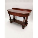 19th. C. mahogany bow front side table on turned columns and gallery back {87 cm H x 115 cm W x 56 c