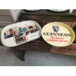 Two Guinness advertising drinks' trays.