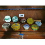 Collection of nine vintage ointment tins.