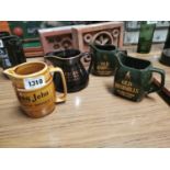 Four advertising jugs