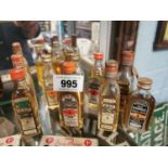 Collection of Whisky miniature bottles with contents.