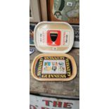 Two Guinness advertising trays