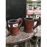 Two leather tankards.