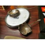 Silver plated tea strainer and tray.