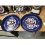 Two Harp advertising drinks' trays.