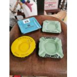 Four enamel advertising ashtrays.