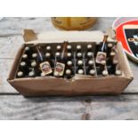 Collection of miniature Guinness advertising bottles.