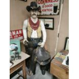 Large fibre glass model of a cowboy.