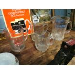Four glass advertising jugs.