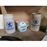Two Lowenbrau advertising tankards and Tennent's Lager advertising jug.