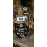 Dow's Port bottle in straw basket.