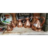 Set of five graduating copper measures.