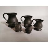 Set of five pewter measures.