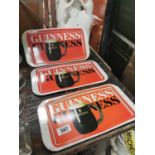 Three Guinness ashtrays.