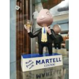 Martell Cognac advertising figure.