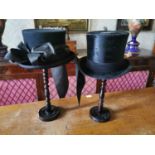 Two top hats on original stands.