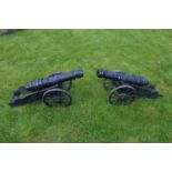 Pair of cast iron models of cannons.