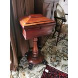 Good quality William IV mahogany tea poy on turned column and platform base raised on lion paw feet