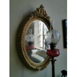 Pair of oval gilt wall mirrors.