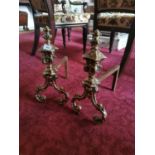 Pair of decorative brass and metal fire dogs. {