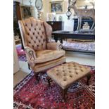 Leather upholstered wing back armchair