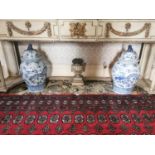 Pair of Oriental blue and white lidded vases. .