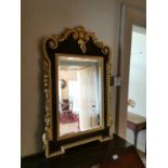 Walnut and parcel gilt wall mirror.