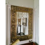 Art Nouveau embossed brass wall mirror.