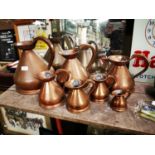 Set of seven copper measures.