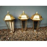 Three brass pub lanterns.