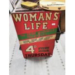 Women's Life advertising sign.