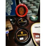 Three Guinness tin plate advertising ashtrays.