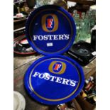 Two Foster's tinplate drink's trays