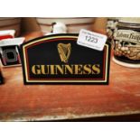 Two Guinness advertising shelf signs.