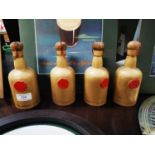 Four Guinness carletonware ceramic bottles.