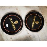 Two Guinness advertising drinks trays