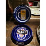 Two Harp Lager tinplate ashtrays.