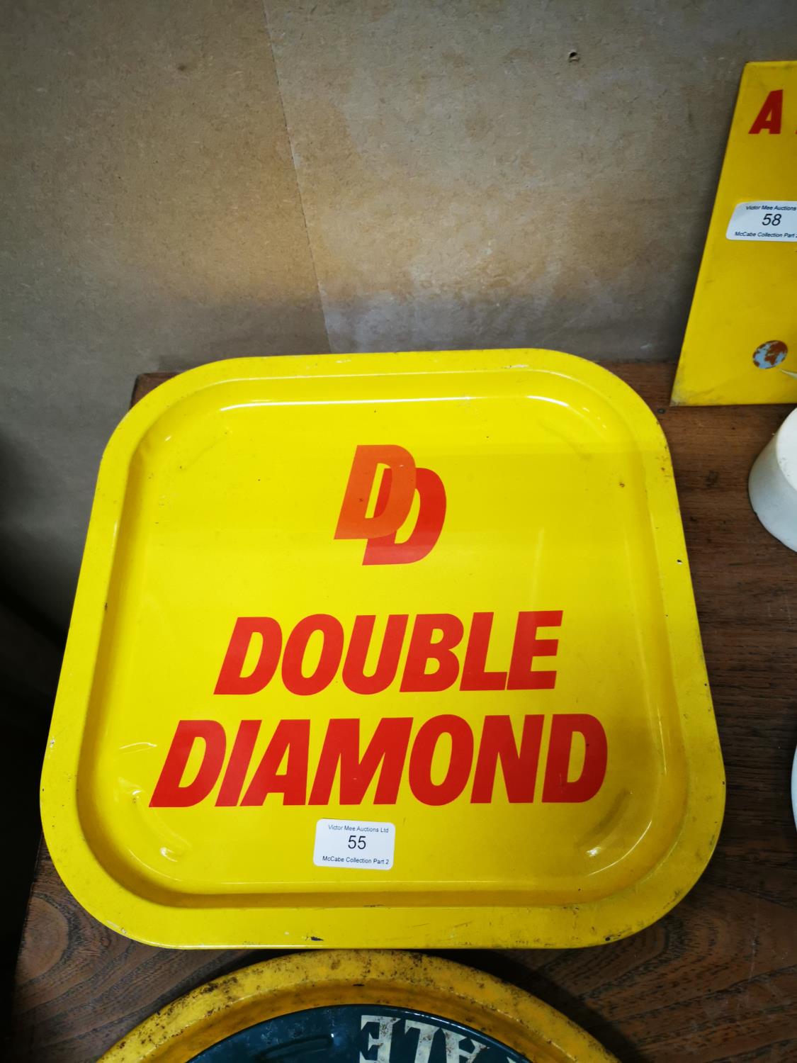 Two Double Diamond advertising tinplate trays .