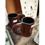 Two leather tankards.